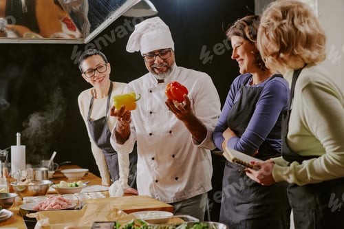 Preview: Middle Aged Man Teaching Cooking Class to Diverse Women in Kitchen