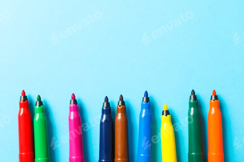 Preview: Flat lay composition with multicolor markers on blue background, space for text