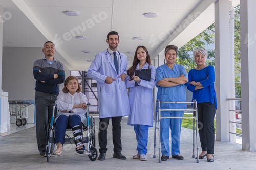 Preview: Doctors and nurse in hospital corridor with senior female and senior male patient