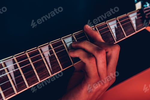 Preview: Close up photo of male hands playing guitar