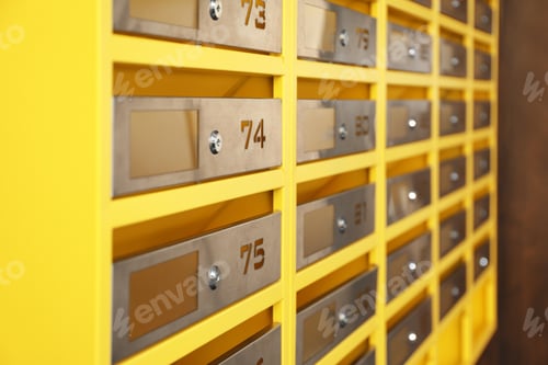 Preview: Many closed metal mailboxes with keyholes and numbers in post office, closeup