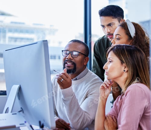 Preview: Shot of a group of businesspeople working together on a computer in an office