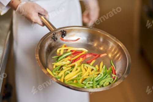 Preview: Fragment photo of cook with pan full of cut peppers