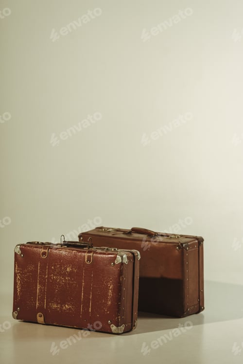 Preview: vintage brown leather travel bags on beige with copy space