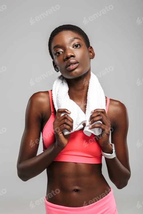 Preview: Image of african american sportswoman with towel looking at camera