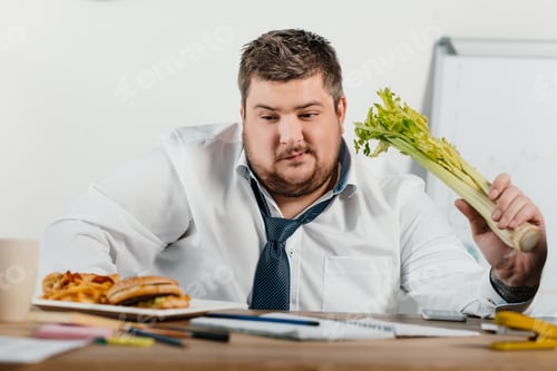Preview: thoughtful overweight businessman choosing healthy or junk food at workplace in office