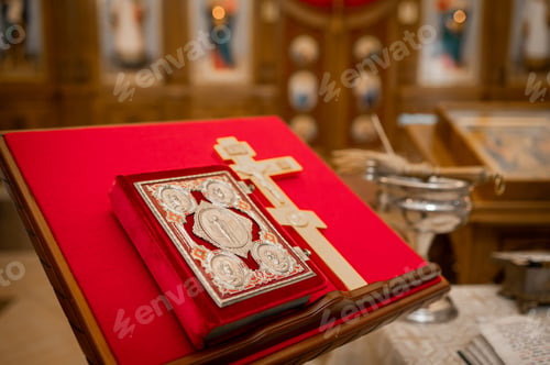Preview: Vintage silver book and golden cross on red velvet stand in elegant interior
