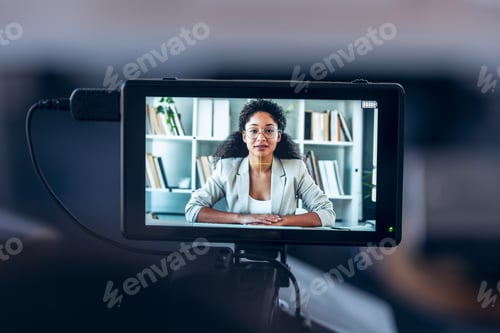 Preview: Camera recording to elegant business woman listening while doing video call in a modern start up.