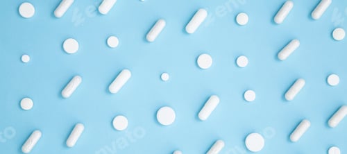 Preview: Various white medication tablets and capsules on blue background. Concept of healthcare
