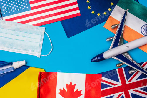 Preview: Top view of toy plane near medical mask and flags of countries on blue background
