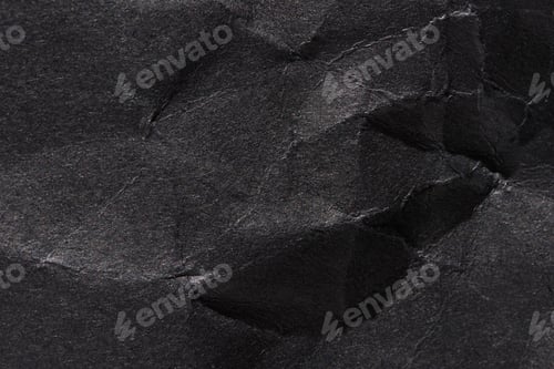 Preview: Close-up of crumpled black paper texture with detailed creases and wrinkles