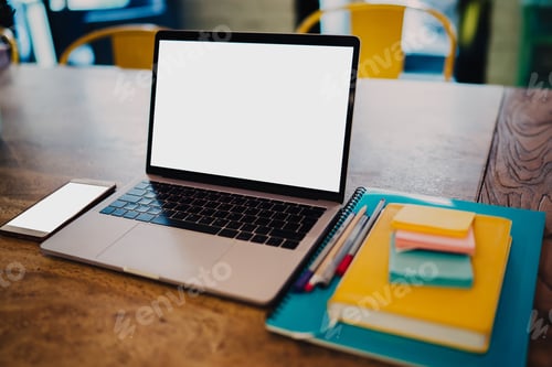 Preview: Wooden table with stationery and laptop
