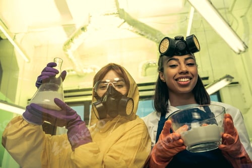 Preview: portrait of women in uniforms holding flask and bowl with reagents in laboratory, drugs concept