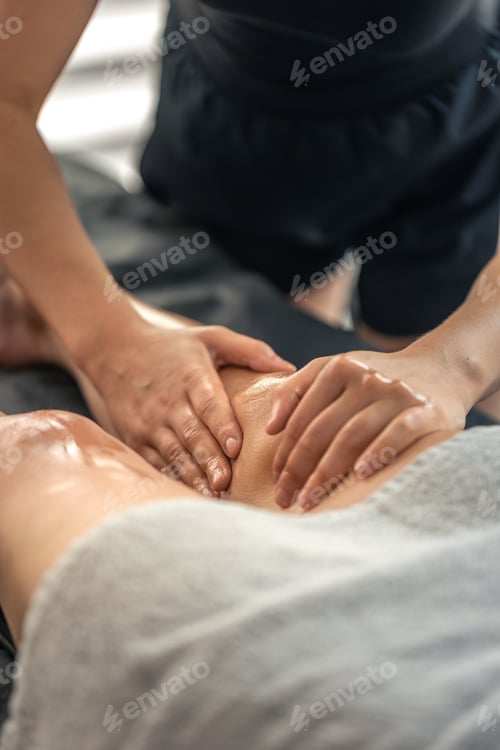 Preview: Leg massage with warm oil on spa table. Relax ritual.