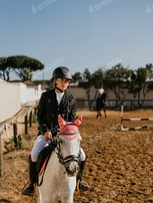 Preview: 14 year old teenager jogging white horse with pink earmuffs