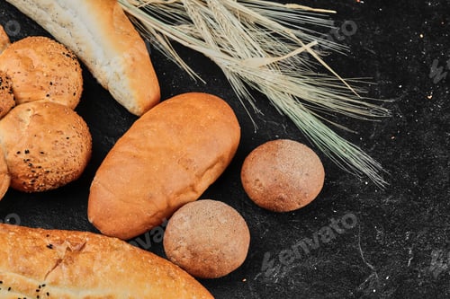 Preview: Various freshly homemade bread on dark background