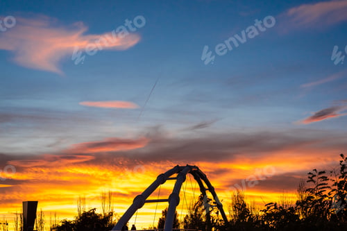 Preview: Warm sunset and silhouette of suspended bridge in the city of Valencia, Spain.