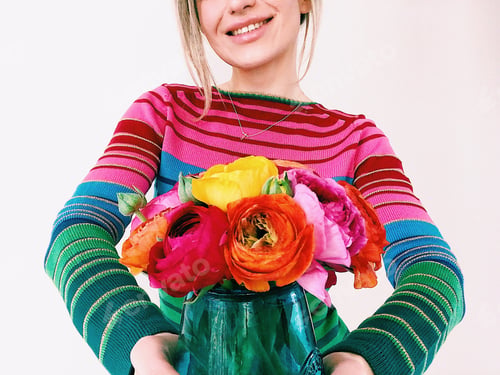 Preview: A smiling girl holding a colorful bouquet of ranunculus