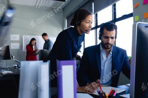 Preview: Business people working with headset phone in office