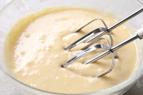 Preview: Making dough in bowl with hand mixer, closeup