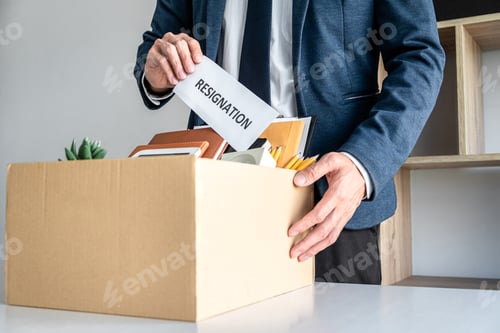 Preview: Images of businessman carrying packing up all his personal belon