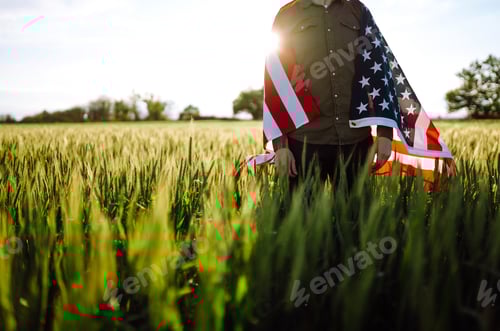 Preview: Man hold waving american USA flag. Patriot raise national american flag. Independence Day, 4th July.