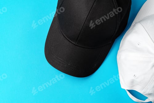 Preview: Baseball caps on blue background studio shot