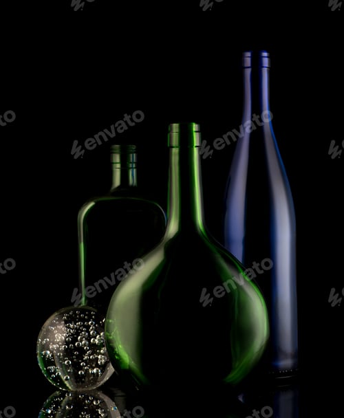 Preview: Still life of glass bottles on a black background