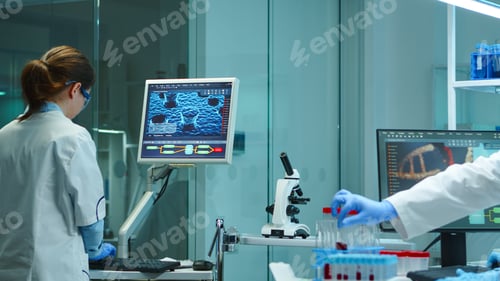 Preview: Chemist nurse typing on computer standing in lab