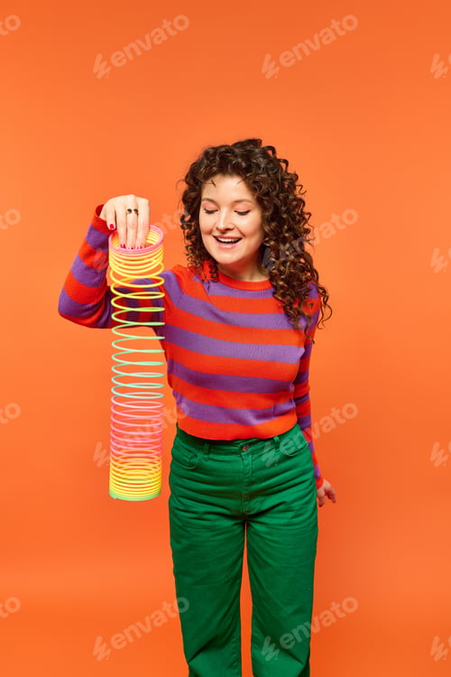 Preview: A smiling girl with rainbow slinky