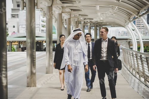 Preview: Business partners team walking down and discussing work.