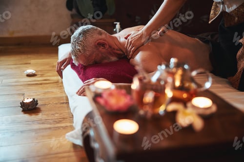 Preview: Man having rest in oriental spa centre