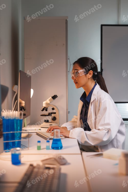 Preview: Female scientist analyzing research data in laboratory