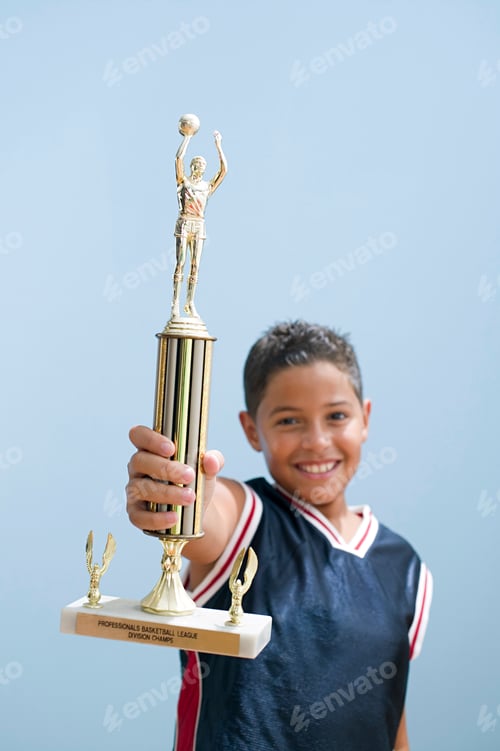 Preview: Boy holding up basketball trophy