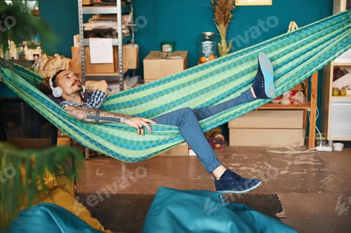 Preview: Handsome young man listening to music at home