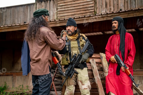 Preview: Group of men with soldier and arab clothes stand with holding hand look like join to fight the enemy