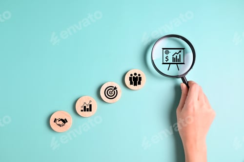 Preview: Hand putting business icons on wooden cubic blocks
