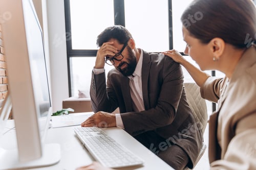 Preview: Businesswoman comforting sad businessman in office