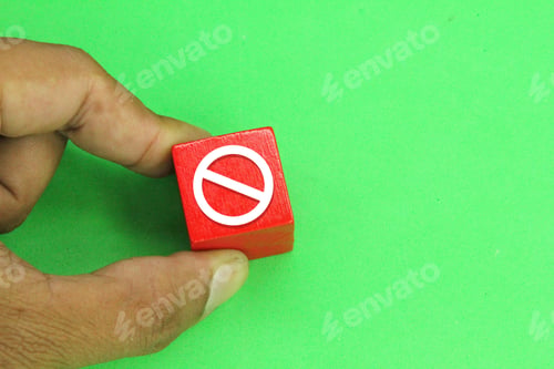 Preview: hand holding a red cube sign forbidden or not.