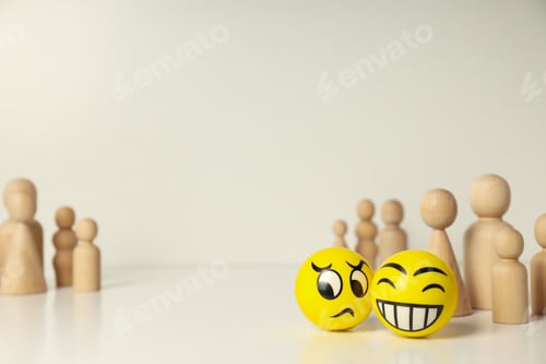 Two Emoji Spheres with Wooden Figures on Table