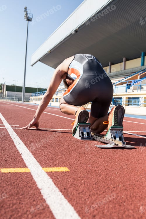 Preview: Runner on tartan track in starting position