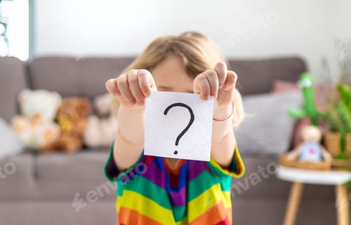 Preview: Question mark in the hands of a child. Selective focus.