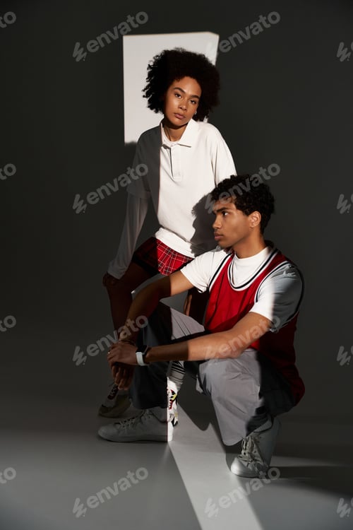 Preview: Stylish young couple embracing love in a modern, artistic setting with playful light and shadow