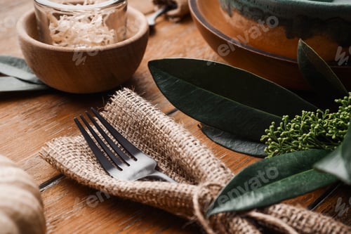 Preview: Fork wrapped in burlap on wooden background, closeup. Table setting element