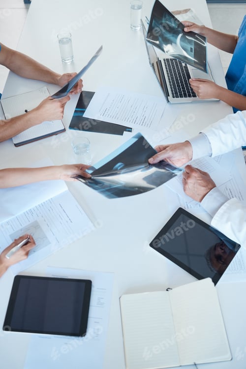 Preview: Shot of a group of medical staff in a meeting looking at x-rays