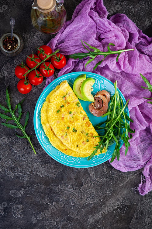 Preview: Fried omelette with ham, onion and herbs. Breakfast with scrambled eggs