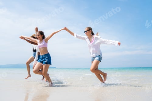 Preview: Happy friends at beach party runs together on the beach.