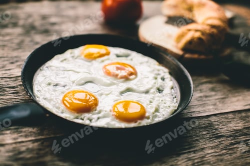 Preview: Fried egg in a frying pan on a wooden table