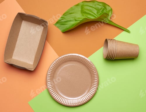 Preview: Disposable paper utensils from brown craft paper and recycled materials on a orange green background