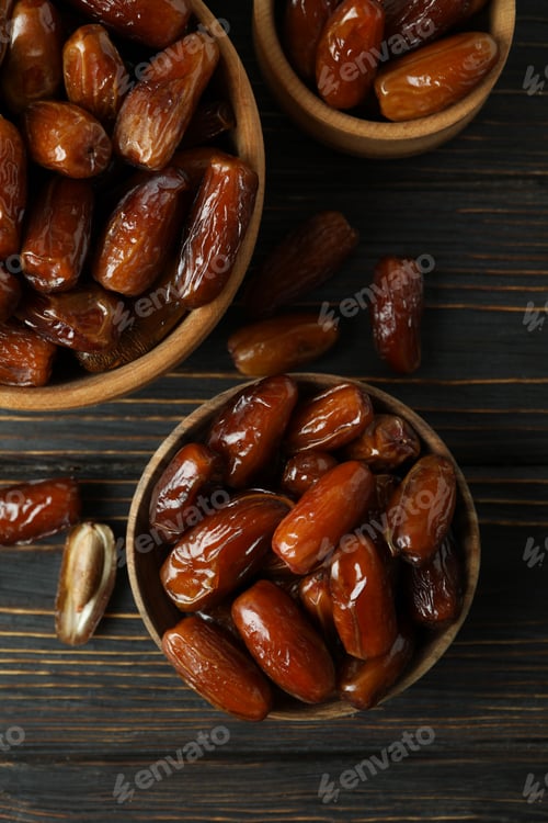 Preview: Bowl with dried dates on wooden table